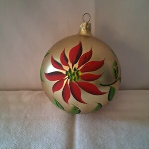 Elegant Gold Ornament with Red and Green Floral Design